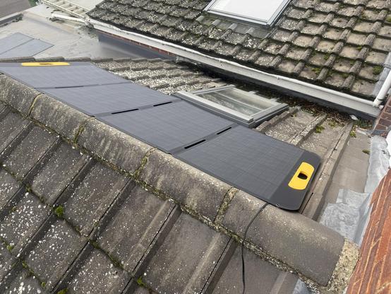 Another angle on the four solar panels showing each one to be about as wide as a Velux window. Even more solar panels are peeking out from a flat roof in the background.