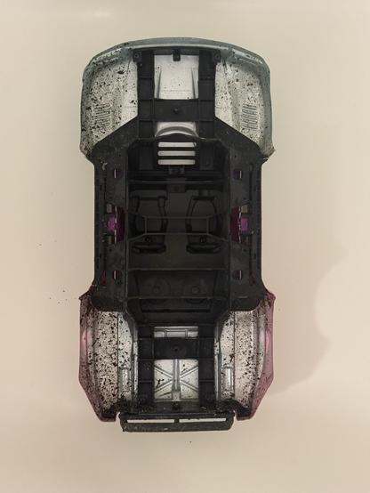 The top shell of the car with mud splashed up into the wheel arches.