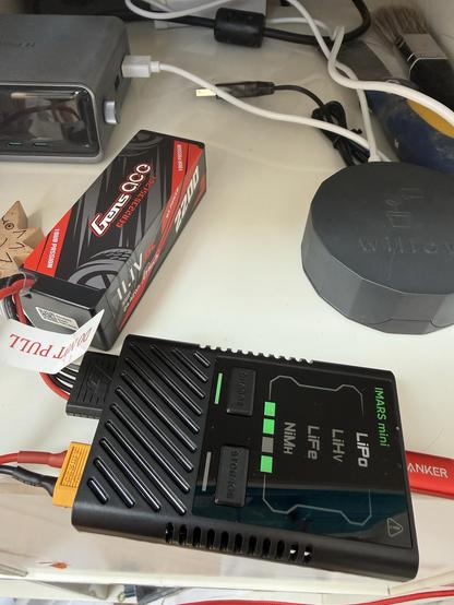 A boxy 11.1v 3s RC LoPo connected to a compact USB C charger.