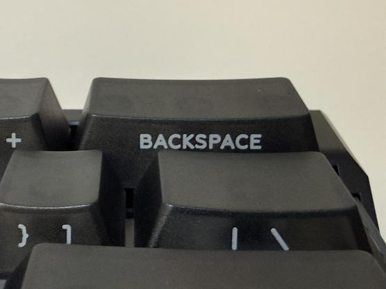 A closeup of the BACKSPACE key showing fairly clean printing and consistent lettering.