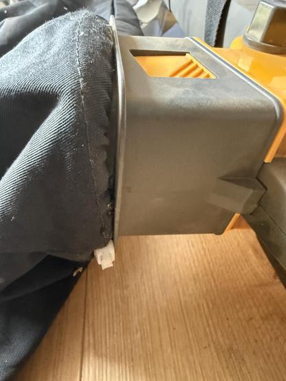 A closeup of a white zip tie securing the bag to the plastic clip.