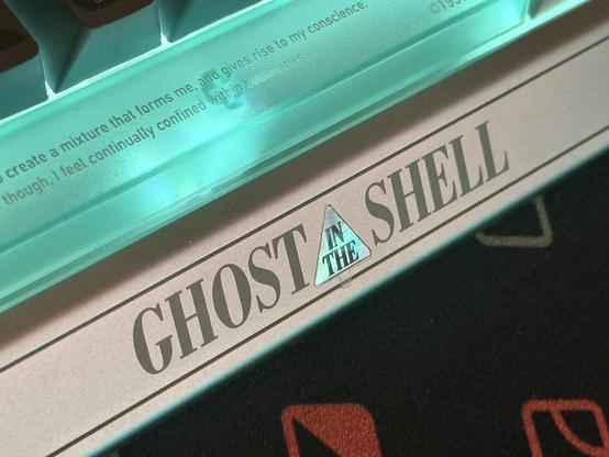 The front badge of the IQUNIX Shell Core EV63, emblazoned with the Ghost In The Shell logo from the 1996 movie. There’s also a quote from the film in very small text on the spacebar.
