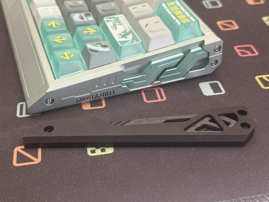 The side caps of the keyboard, a stock EV63 cap laid next to the Shell Core board. They have very different construction and materials - acrylic in the Shell Core vs carbon fibre details in the stock EV63 - though the basic shape is similar.