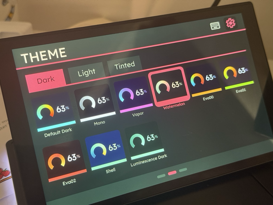 A list of themes with detailed previews of their colours in the theme icons. Three tabbed groups - dark, light and tinted - sit along the top.